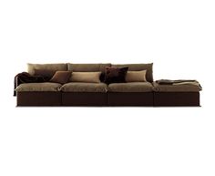 a brown couch with pillows on top of it and a blanket over the armrests