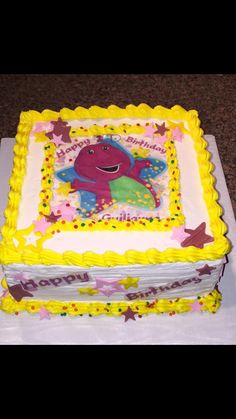 a birthday cake with an image of a dinosaur on the top and stars around it