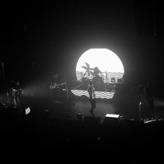 a man standing on top of a stage under a light