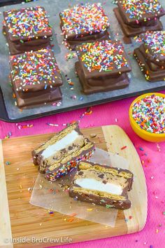 chocolate and sprinkles are arranged on a cutting board