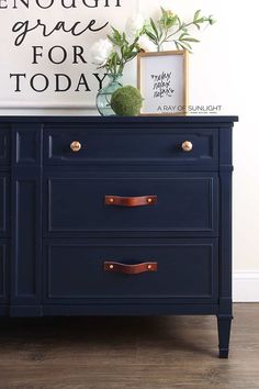 a blue dresser with two drawers and a sign above it that says enough grace for today