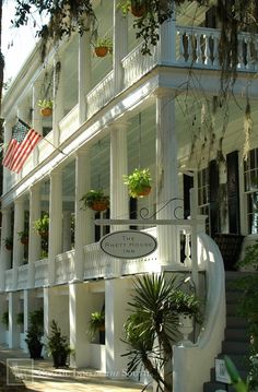 an old white house with many windows and balconies