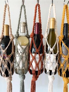 several bottles of wine are hanging from ropes