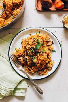 a white plate topped with rice and mushrooms