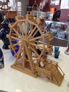 a wooden ferris wheel sitting on top of a table