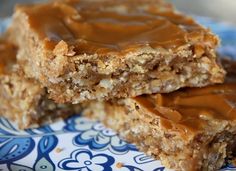 two pieces of peanut butter bars on a blue and white plate