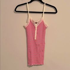 So Cute Thrills By Nordstrom 100% Cotton Strawberry Pink And Creamy White Striped Camisole. Darling Detail In The Front And Pretty Lace Around The Neckline And Arm Area. Wear This Under A Gorgeous Cashmere Sweater, Blazer Or Dress It Down With A Jean Jacket. Or Wear As A Tank To Bed. Very Stretchy And Comfortable. Size Medium. This Is Small Looking But Has Tons Of Stretch Cute Camisole With Lace Trim, Cute Lace Trim Cami Camisole, Cute Lace Trim Camisole, Striped Cami Tank Top For Spring, Fitted Striped Tank Top With Spaghetti Straps, Cute Fitted Tank Camisole, Cute Fitted Tank Top With Spaghetti Straps, Cute Stretch Cami Tank Top, Spring Striped Camisole Tank Top