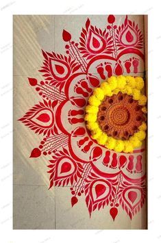 a yellow and red flower sitting on top of a white floor