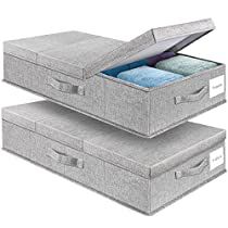 two gray storage boxes with lids open and folded towels in the bottom one is empty