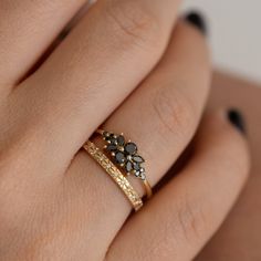 a woman's hand with two rings on it and one is holding the other