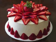 a white cake with strawberries on top