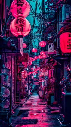 an alley way with red and pink lanterns hanging from it's sides in the dark