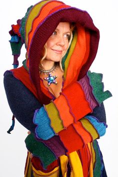 a woman wearing a multicolored hoodie and scarf