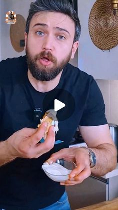 a man holding a plate with food in it and looking at the camera while making a funny face