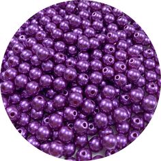 purple pearl beads with holes in the middle and one hole at the top, on a white background