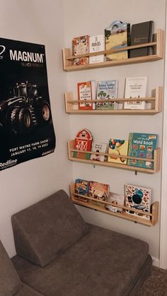 there is a book shelf with books on it and a couch in front of it