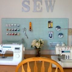 sewing machines are sitting on a table in front of a pegboard with the word sew