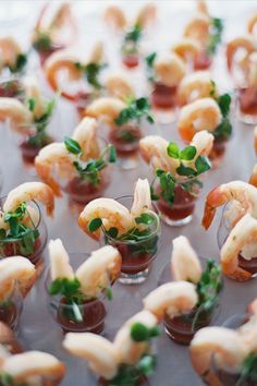 small appetizers with shrimp and garnishes on them