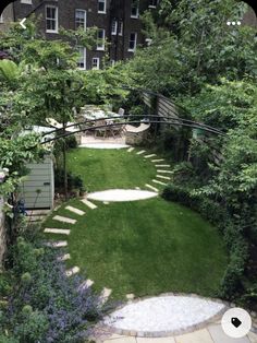 an outdoor garden with stepping stones and green grass