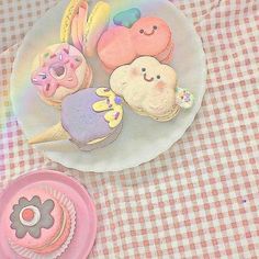 there is a plate that has some cupcakes and donuts on it with icing