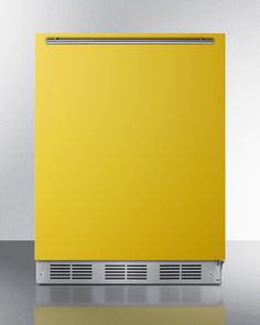 a yellow dishwasher sitting on top of a shiny counter next to a white wall