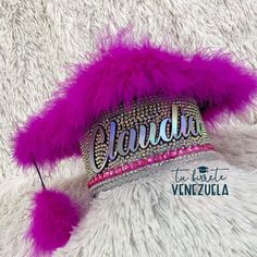 a tiara with purple feathers and name written on it