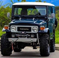 a black and white toyota truck driving down a road