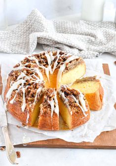 a bundt cake with white icing sitting on top of a cutting board