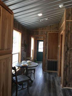 a dining room with wooden walls and flooring