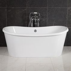 a white bath tub sitting in a bathroom next to a black tiled wall and floor