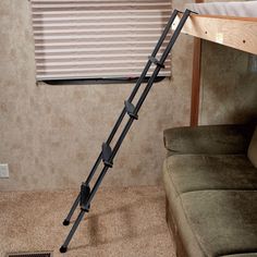 a ladder leaning up against the wall near a couch