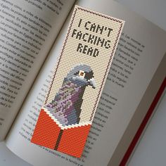 a cross stitch bookmark with an image of a bird on it