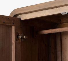 an open wooden cabinet with metal latches