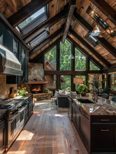 an open kitchen and living room area with wood flooring, vaulted ceiling and large windows