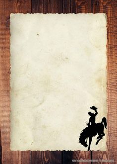 an old paper with the silhouette of a cowboy riding a horse on wooden planks