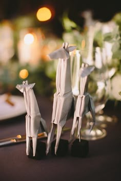 two origami giraffes are sitting next to each other on a table