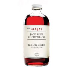 a bottle of jack ruddy cocktail co small batch ginnie on a white background