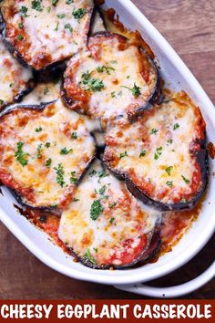 eggplant casserole with cheese and parsley in a white dish on a wooden table