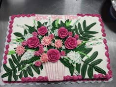 a cake decorated with flowers and leaves on a table