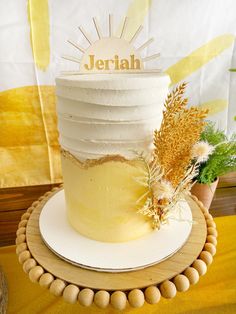 there is a white cake that has been decorated with wheat and the name jeriah on it