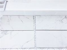 white marble tiles are laid out on the floor