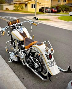 a white and orange motorcycle parked on the street