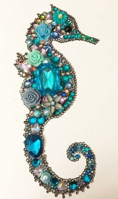 a seahorse made out of beads and jewels