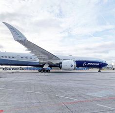 an airplane is parked on the tarmac with another plane in the back ground behind it