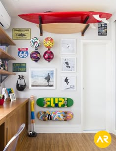 there is a surfboard mounted to the wall in this room with pictures on it