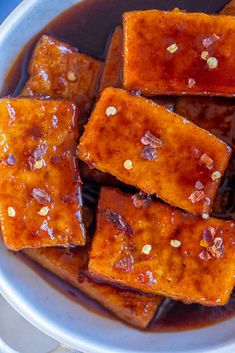 tofu with sauce in a white bowl on a table