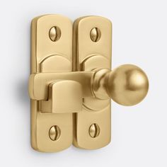 a golden door handle on a white background