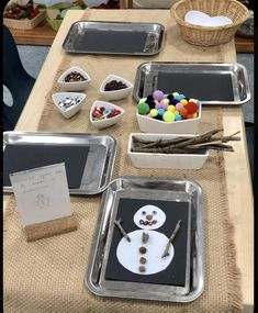 some trays filled with different types of candy and candies on top of a table