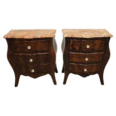 two wooden drawers with marble top tops on each side, one is brown and the other is white