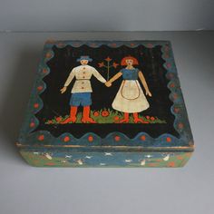 an old painted box with two people holding hands